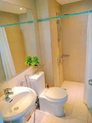 a bathroom with a toilet and a sink and a shower at Azure Condo by arlene in Manila