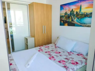 a bedroom with a bed with pink flowers on it at Azure place by arlene in Manila