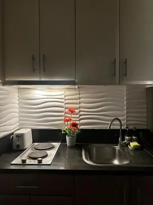 a kitchen counter with a sink and a stove at The Chic Studio at 150 Near NAIA Terminal 3 in Manila