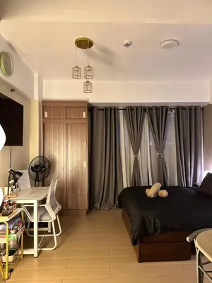 a bedroom with a bed and a table and a desk at The Chic Studio at 150 Near NAIA Terminal 3 in Manila