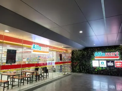 a restaurant with tables and chairs in a store at Cozy Two-Bedroom Suite, Coast Residences, Pasay in Manila