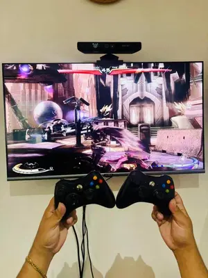 a person holding a video game controller in front of a tv at Azure staycation by Marco in Manila