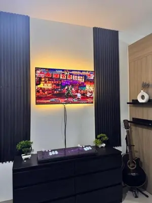 a room with a dresser with a tv on the wall at Wander & Chill Staycation in Manila
