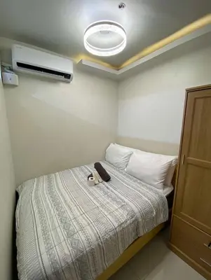 a bedroom with a bed with a stuffed animal on it at Comfort Cove at Shore 3 in Manila