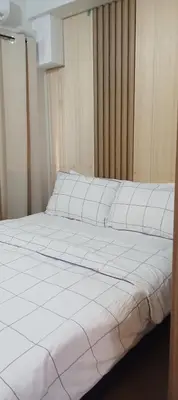 a large white bed in a room at One Bedroom Apartment near MOA in Manila