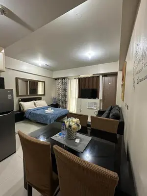a living room with a dining table and a living room at One Bedroom Apartment near MOA in Manila