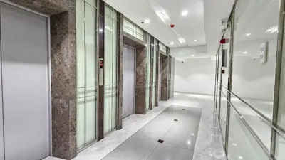 an empty hallway with glass doors in a building at Chic Studio near Megamall and Shangrila Plaza in Manila