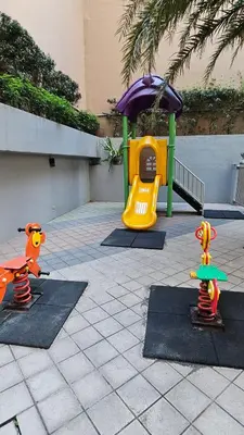 a childrens playground with a play set and a slide at Chic Studio near Megamall and Shangrila Plaza in Manila