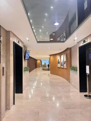 an empty lobby with a television in a building at Shore 2 Residence in Manila