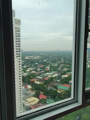 a view of a city from a window at Pixie Dust Suite in Manila