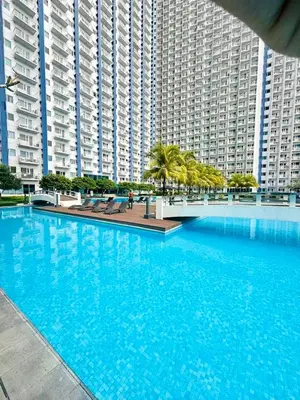 a large swimming pool in front of a large building at Jazz Residences Makati Tower B in Manila