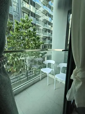 a view of a balcony with white chairs and a window at LDN Two Palm Tree Villa LFamilia in Manila