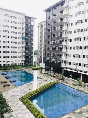 a view of two apartment buildings and a swimming pool at Charm Residences Building E in Manila