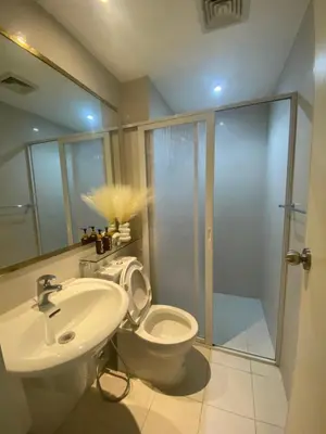 a bathroom with a toilet and a sink and a shower at Azure Staycation PH 1503 in Manila