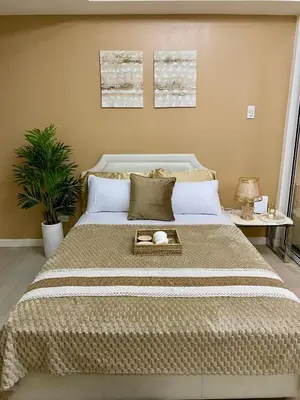 a bedroom with a large bed with a tray on it at Azure Staycation PH 1503 in Manila