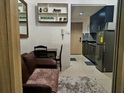 a living room with a couch and a kitchen at Shore Residences MOA Minimalist Room in Manila