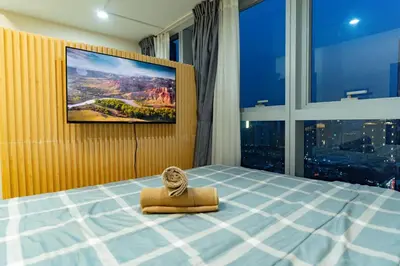 a bedroom with a bed with an elephant on it at Spacious 3BR Suite in Uptown BGC with King Size Bed, near Malls and Restaurants in Manila