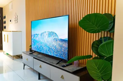 a flat screen tv sitting on top of a dresser at Spacious 3BR Suite in Uptown BGC with King Size Bed, near Malls and Restaurants in Manila