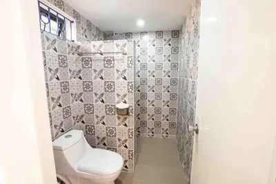 a small bathroom with a toilet and a shower at Private Resort in upper Antipolo in Antipolo