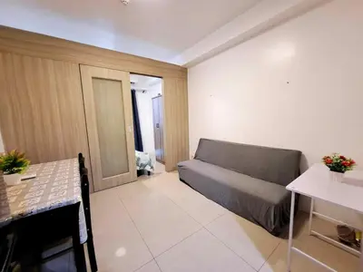 a living room with a couch and a table at Wooden style amenities view in Manila