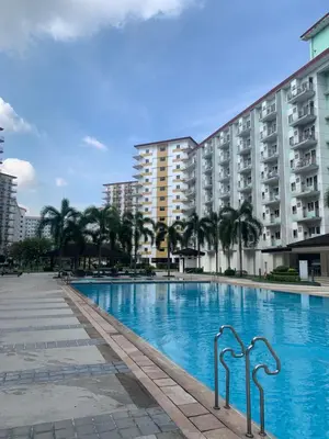 a large swimming pool in front of a building at PEACETIME CONDO FIELD RESIDENCES BLDG 6 u1006B in Manila