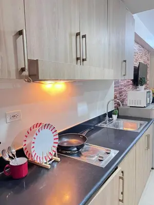 a kitchen counter top with a bowl and a plate on it at Unistay SHORE Residence w Balcon Amazing Manila Bay View in Manila