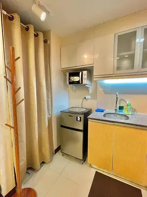 a small kitchen with a sink and a stove at NAIA Terminal 3 Condo Newport with WIFI Netflix Pool in Manila