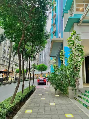 a car is driving down a city street with trees at NAIA Terminal 3 Condo Newport with WIFI Netflix Pool in Manila