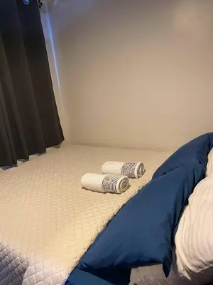 a bed with two pillows on top of it at 1 BR Condo w Balcony in Air Residence Makati in Manila