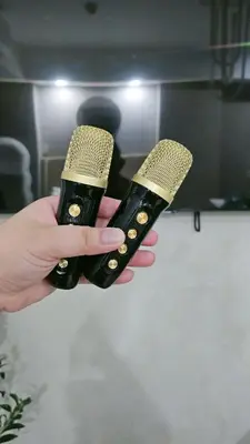 a person holding two microphones in their hands at Cozy Apartment Azure Urban Resort Residences in Manila