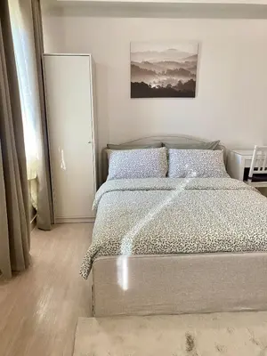 a bedroom with a bed and a painting on the wall at Condo unit near SM City Sta Rosa Unit 2 in Ibaba