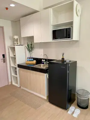 a kitchen with a black refrigerator and a sink at Condo unit near SM City Sta Rosa Unit 2 in Ibaba