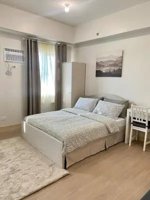 a bedroom with a bed and a window at Condo unit near SM City Sta Rosa Unit 2 in Ibaba