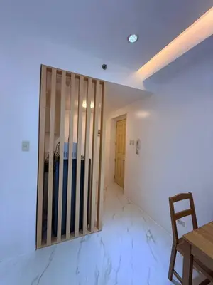 a room with a wooden partition with a table and a door at Malate Bayview Mansion Korean Town 1Bedroom in Manila