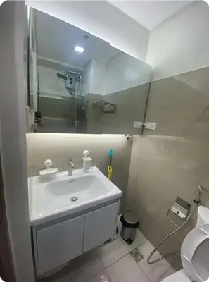 a bathroom with a sink and a toilet at Modern Comfort at Shore 2 MOA in Manila