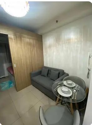 a living room with a couch and a table at Modern Comfort at Shore 2 MOA in Manila