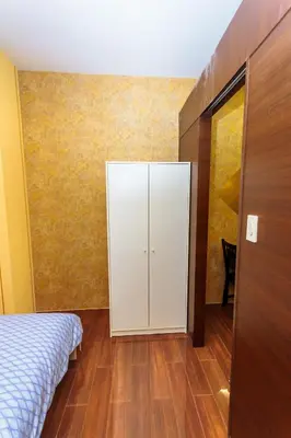 a bedroom with a white cabinet and a wooden floor at City of Dreams Luxury Makati 5637 Swim Gym Netflix Superfast Surfing in Manila