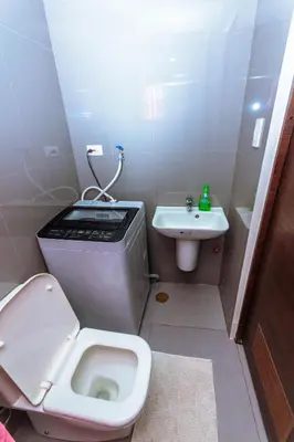a small bathroom with a toilet and a sink at City of Dreams Luxury Makati 5637 Swim Gym Netflix Superfast Surfing in Manila