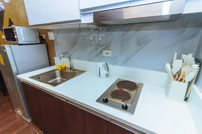 a kitchen counter with a sink and a stove at City of Dreams Luxury Makati 5637 Swim Gym Netflix Superfast Surfing in Manila