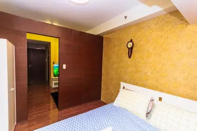 a bedroom with a blue bed and a wooden wall at City of Dreams Luxury Makati 5637 Swim Gym Netflix Superfast Surfing in Manila