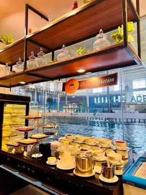 a buffet of food with a pool in the background at Cozy Laura at ACE Plaza in Manila
