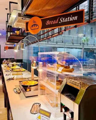 a bakery with a display of food on a counter at Cozy Laura at ACE Plaza in Manila