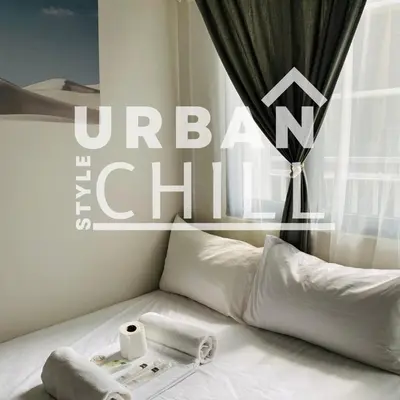 a white bed with a towel and toilet paper on it at Urban Style Chill with Free Parking, Shore 3, MOA Complex Pasay, Manila in Manila