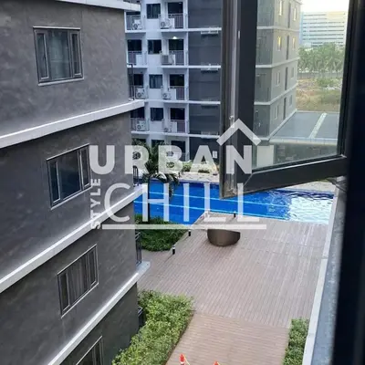 a view of a swimming pool from a window of a building at Urban Style Chill with Free Parking, Shore 3, MOA Complex Pasay, Manila in Manila