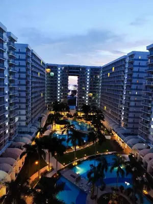 an aerial view of a large building with two pools at Pool view 333d near moa with balcony in Manila