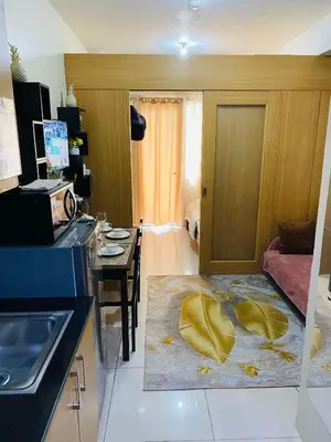 a kitchen with a living room with a table and a room with at Pool view 333d near moa with balcony in Manila