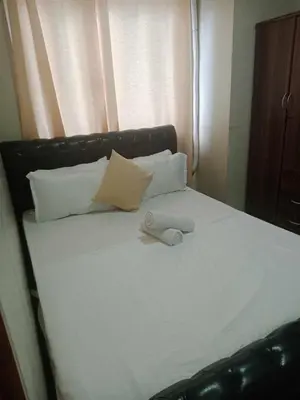 a white bed with pillows and a towel on it at 2bedroom with big balcony 1046D pool view in Manila