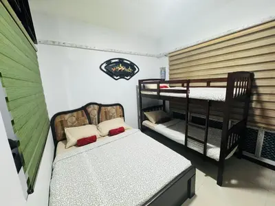 a small room with two bunk beds and a couch at Stamford Residences Fully-furnished in Manila