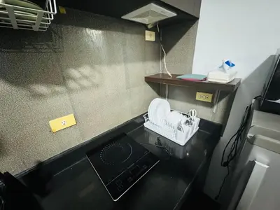 a small kitchen with a sink and a stove at Stamford Residences Fully-furnished in Manila