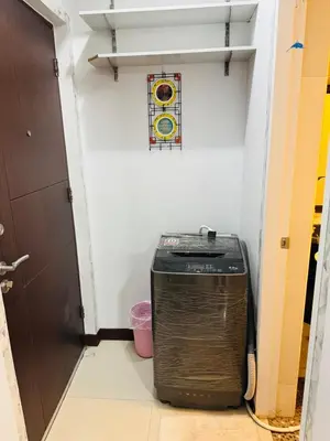 a room with a heater in a hallway with a stained glass window at Stamford Residences Fully-furnished in Manila